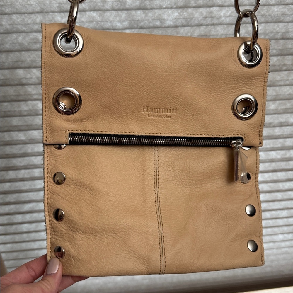 Hammitt Montana reversible leather crossbody bag in a tan and black.